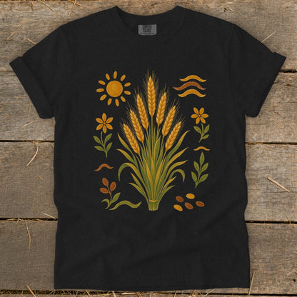 Black t-shirt with wheat stalks, sun, flowers, leaves, and seeds design.