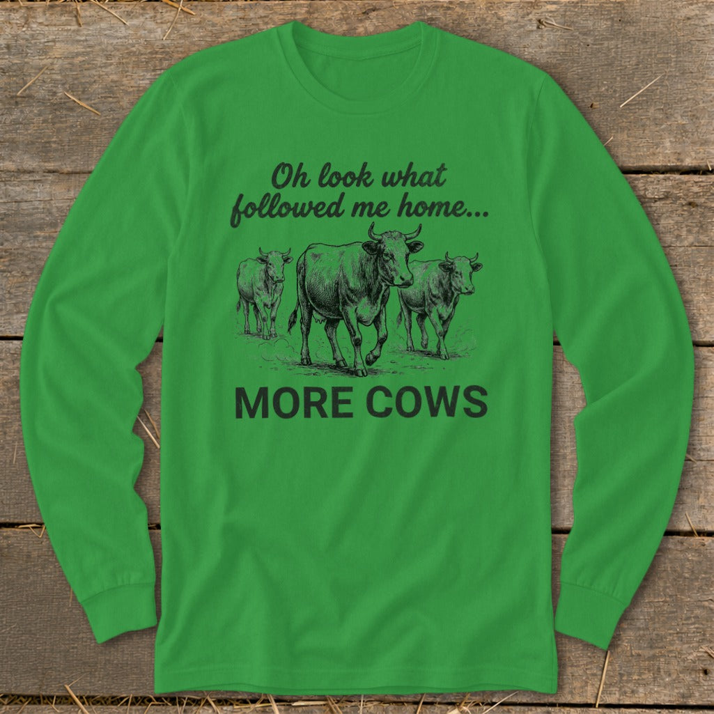 Green long-sleeved shirt with a drawing of three cows and text "Oh look what followed me home... MORE COWS".
