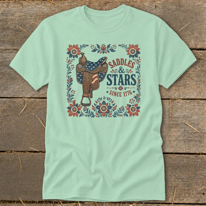 Light mint t-shirt with a vintage saddle and "Saddles & Stars Since 1776" text.