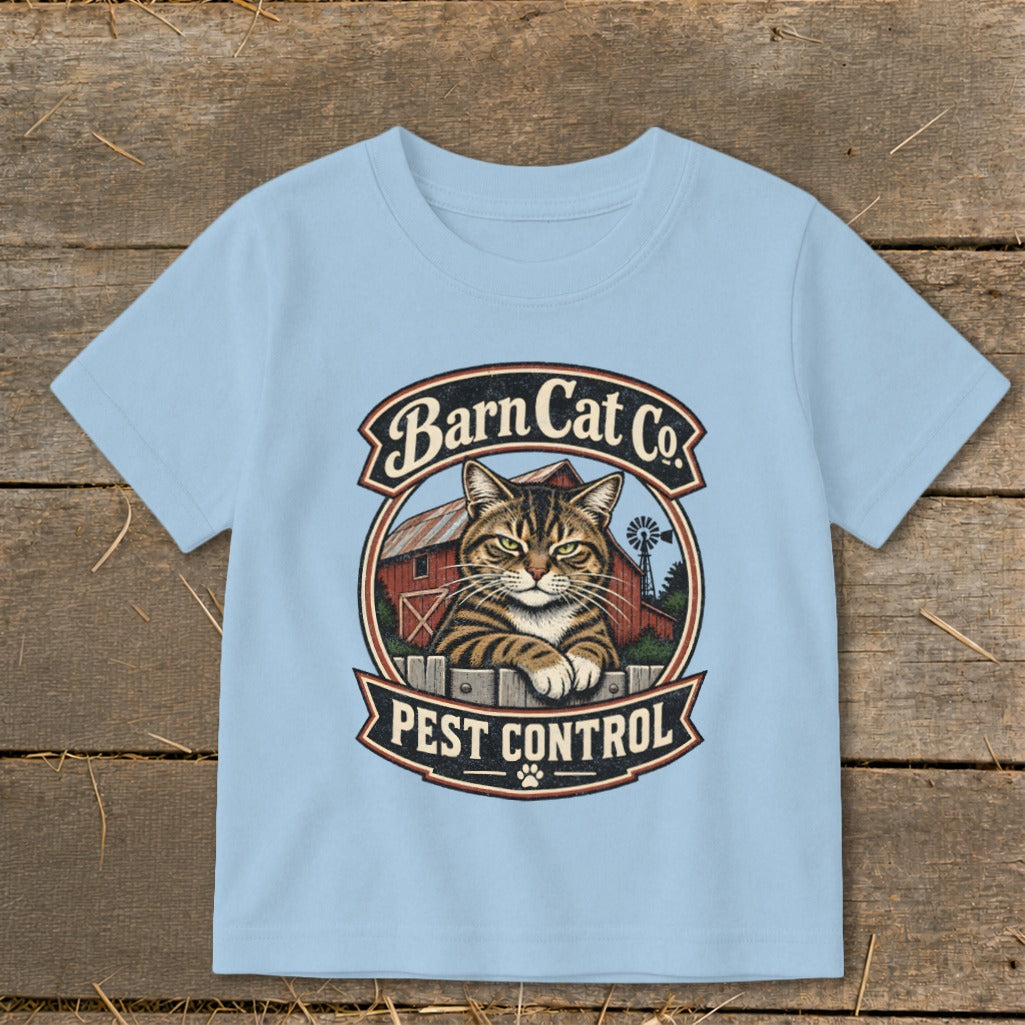 Light blue t-shirt featuring a circular graphic with a tabby cat, barn, and text reading Barn Cat Co Pest Control.
