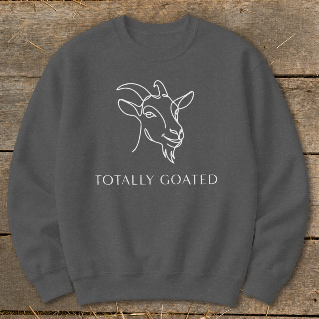 Dark grey sweatshirt with white line art goat and text "TOTALLY GOATED".