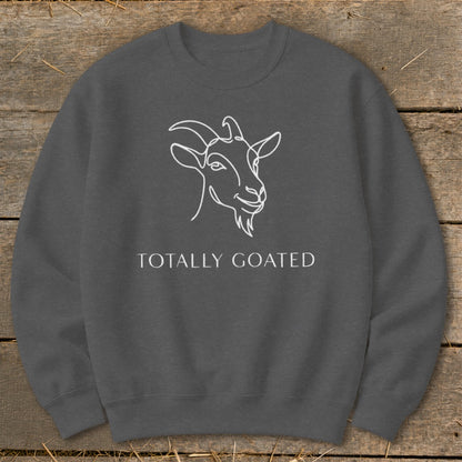 Dark grey sweatshirt with white line art goat and text "TOTALLY GOATED".