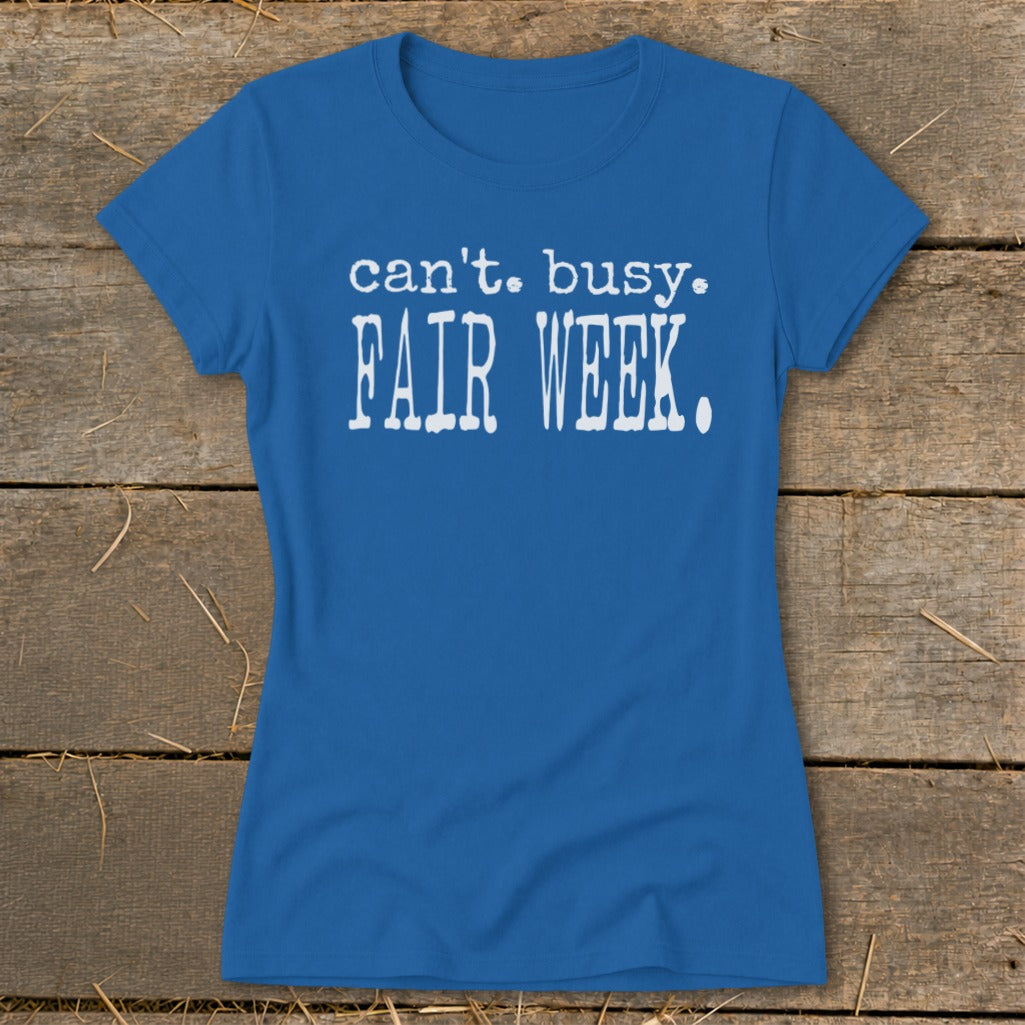 Blue t-shirt with "can't. busy. FAIR WEEK." in white text.
