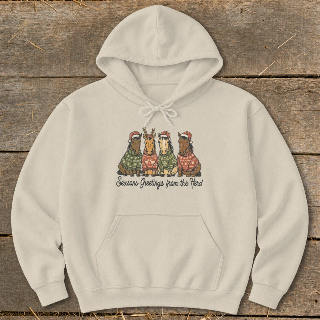 Cream hoodie with four horses wearing Christmas sweaters and hats; text says "Seasons Greetings from the Herd."