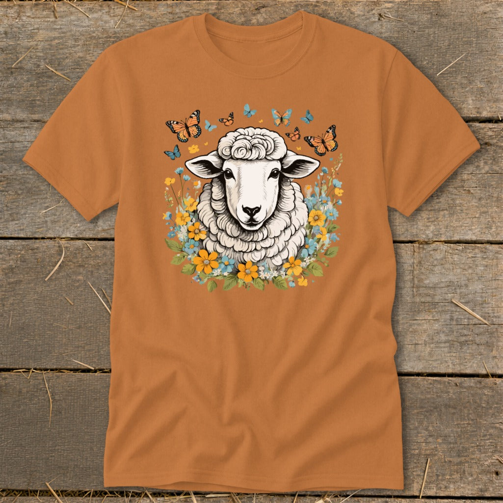 Orange t-shirt with a fluffy sheep graphic surrounded by flowers and butterflies.