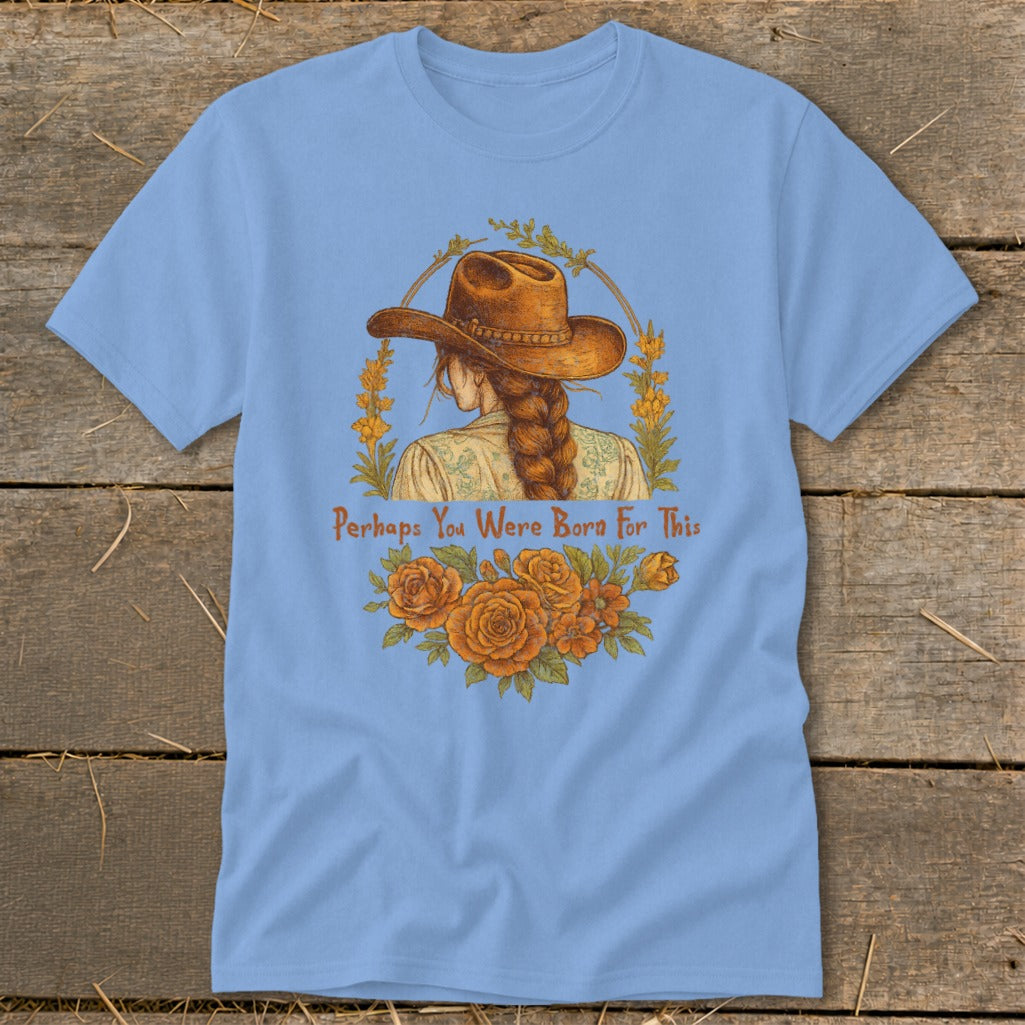 Light blue t-shirt with a cowboy hat and braided hair graphic and text.