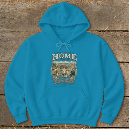 Blue hoodie with "Home Is Where The Herd Is" text and farm scene graphic.