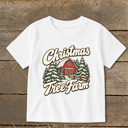 White t-shirt with "Christmas Tree Farm" graphic featuring a red barn and snow-covered pine trees.
