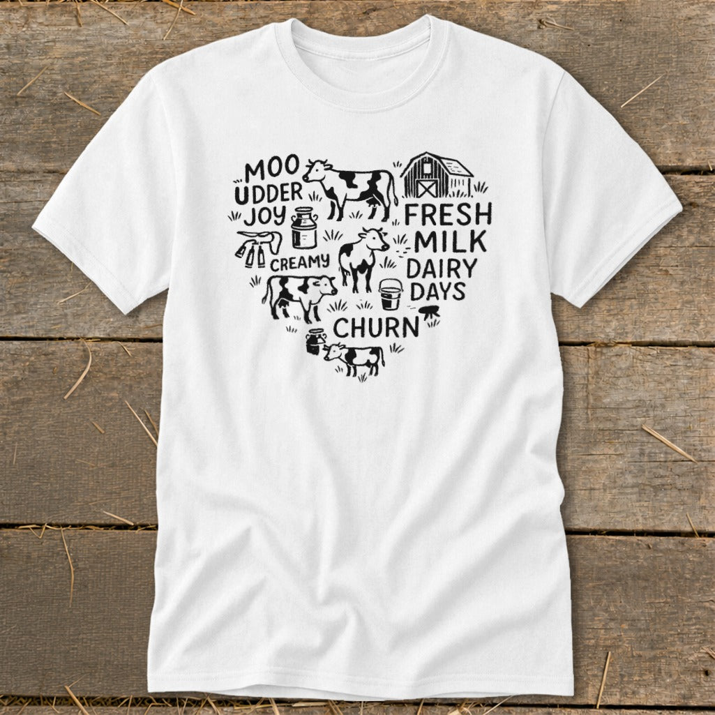 White t-shirt with black heart graphic featuring cows, a barn, and dairy-themed text.