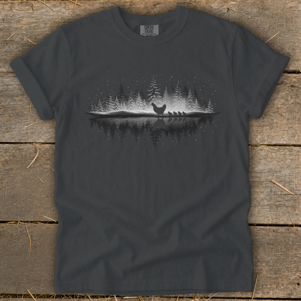 Dark gray t-shirt with a hen and chicks silhouetted by a snowy forest reflection.