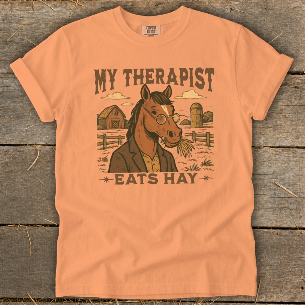 Horse wearing glasses and suit eating hay on a farm, text says "My Therapist Eats Hay".