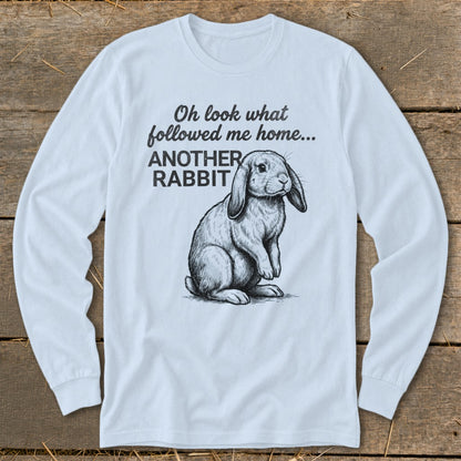 Light blue long-sleeve shirt with a sketch of a rabbit and text "Oh look what followed me home... ANOTHER RABBIT".