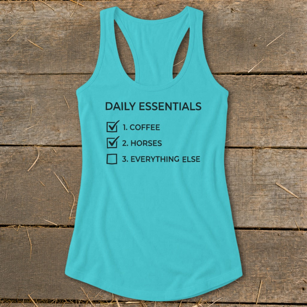Turquoise tank top with "Daily Essentials" checklist: coffee, horses, everything else.