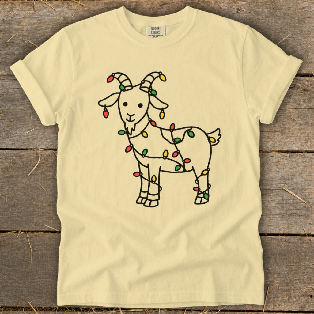 Cream t-shirt with a line drawing of a goat wrapped in colorful Christmas lights.