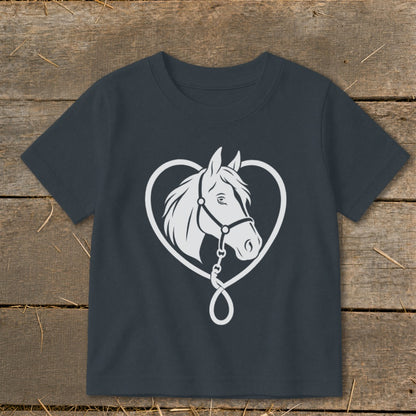 A dark gray t-shirt featuring a white graphic of a horse head inside a heart shape on a wooden background.