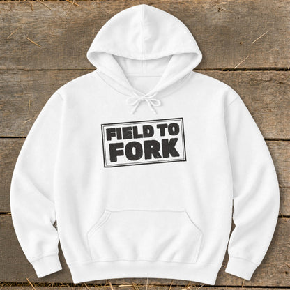 A white hooded sweatshirt with a front pocket features a black boxed graphic that reads FIELD TO FORK.
