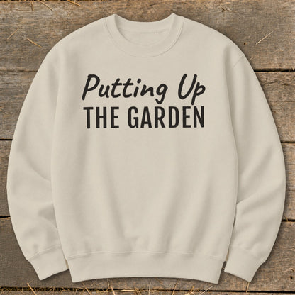 Cream sweatshirt with black text reading "Putting Up THE GARDEN."