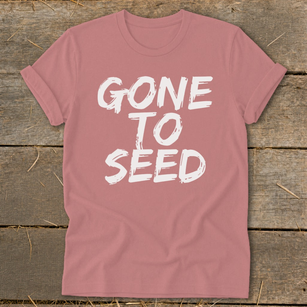 Pink t-shirt with white text that reads "GONE TO SEED"