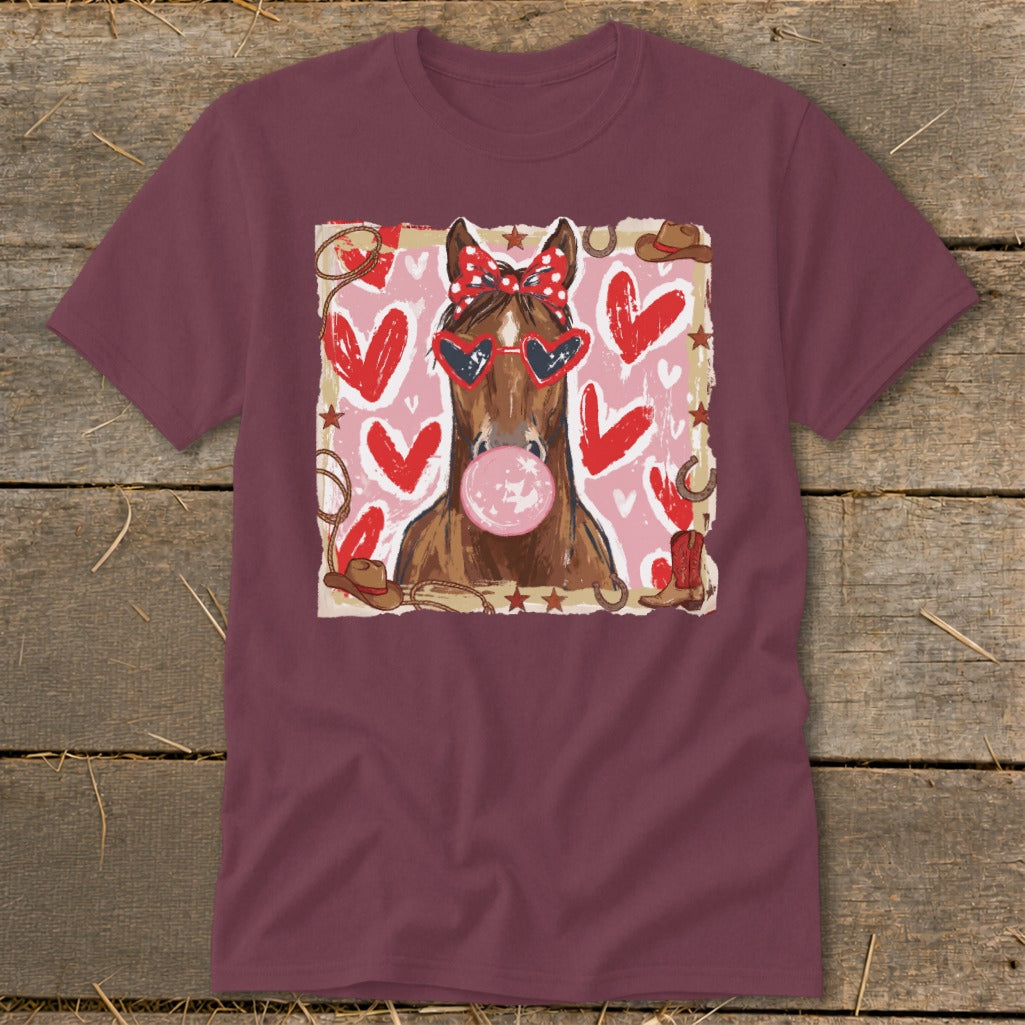 Brown horse with sunglasses and bandana blowing bubblegum surrounded by hearts.