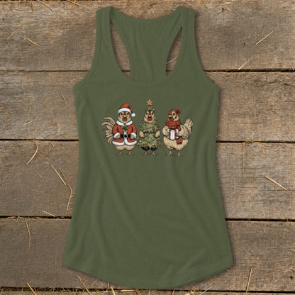 Three chickens dressed for Christmas: one as Santa, one as a tree, one with a scarf.