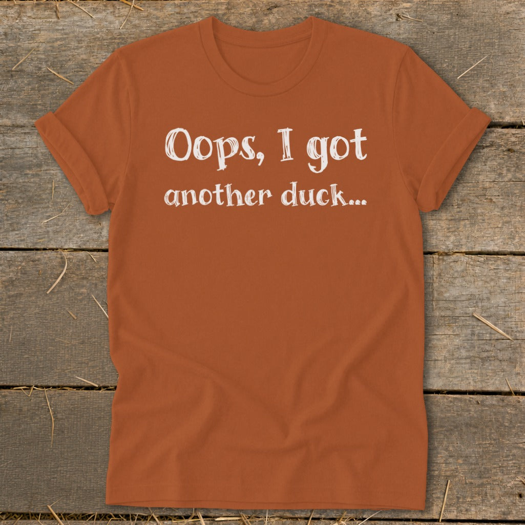 Orange t-shirt with white text reading "Oops, I got another duck..."
