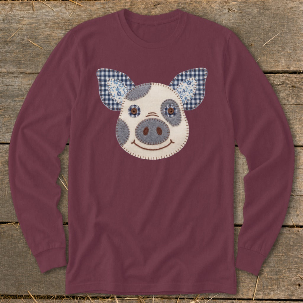 Maroon long-sleeve shirt with a stitched pig face applique and plaid ears.