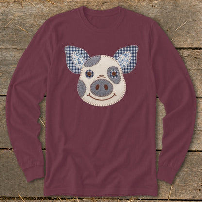 Maroon long-sleeve shirt with a stitched pig face applique and plaid ears.