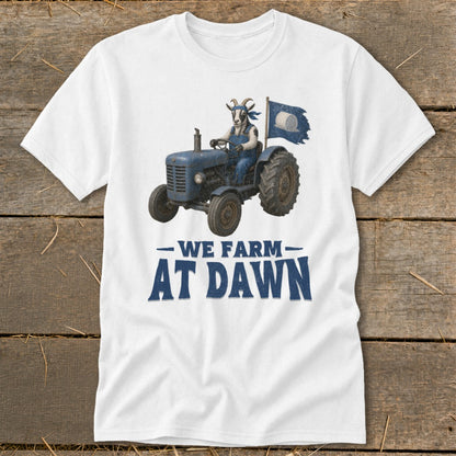 White t-shirt with a goat driving a blue tractor, holding a flag, and text "We Farm At Dawn".