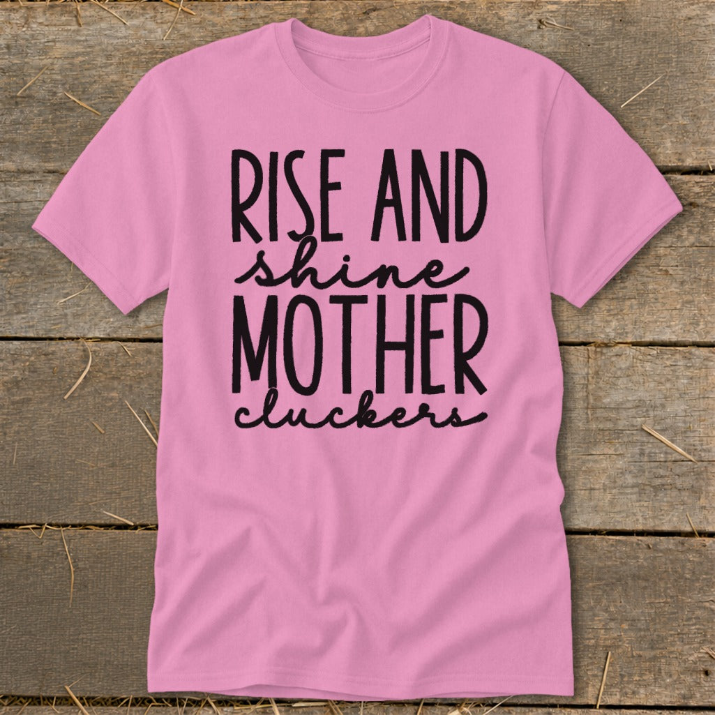 Pink t-shirt with black text: "RISE AND shine MOTHER cluckers".