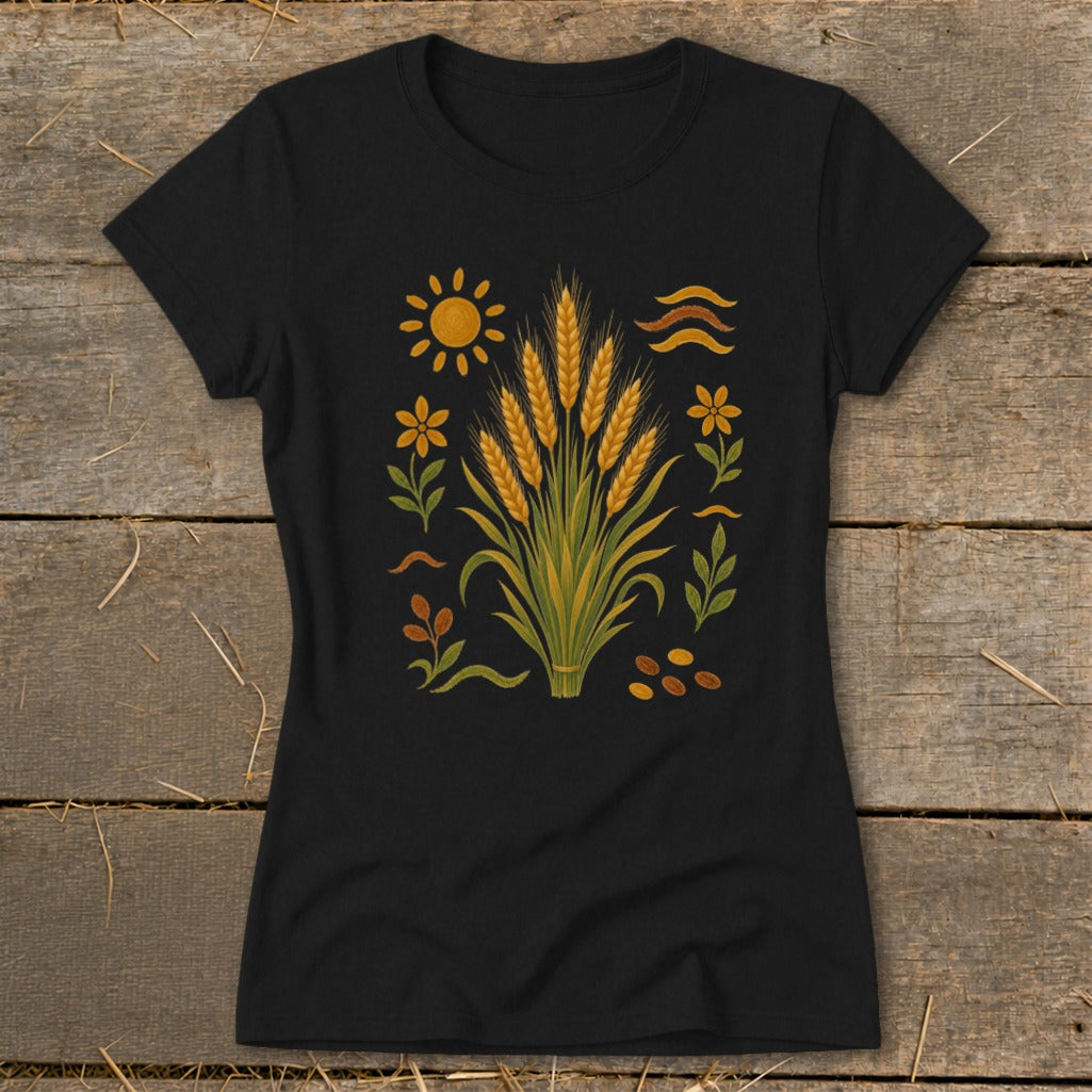 Black t-shirt with a central graphic of wheat stalks, sun, flowers, and seeds.