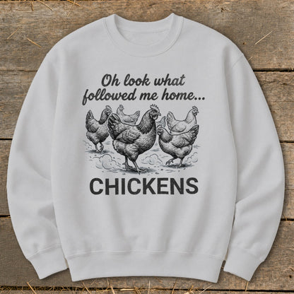 White sweatshirt with "Oh look what followed me home... CHICKENS" and chicken illustration.