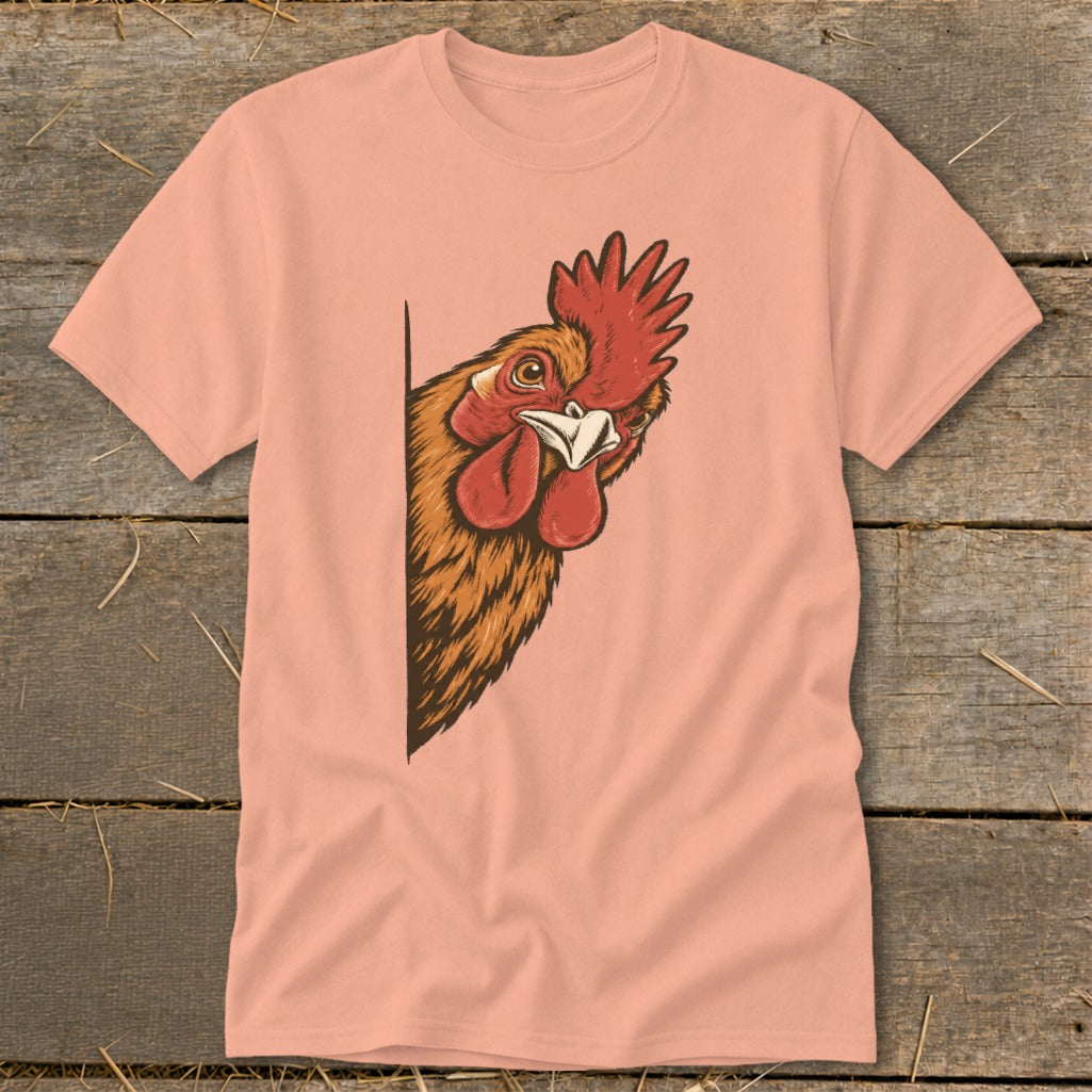 Peach t-shirt with a cartoon rooster peeking from the left edge.