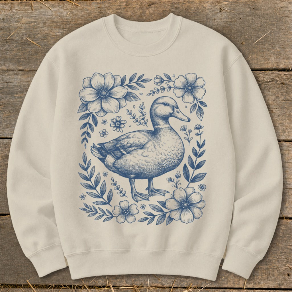 Crewneck sweatshirt with blue duck and floral sketch design.