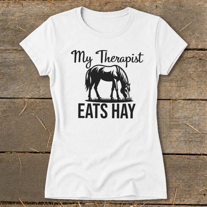 White t-shirt with black text and horse graphic, reading "My Therapist Eats Hay".