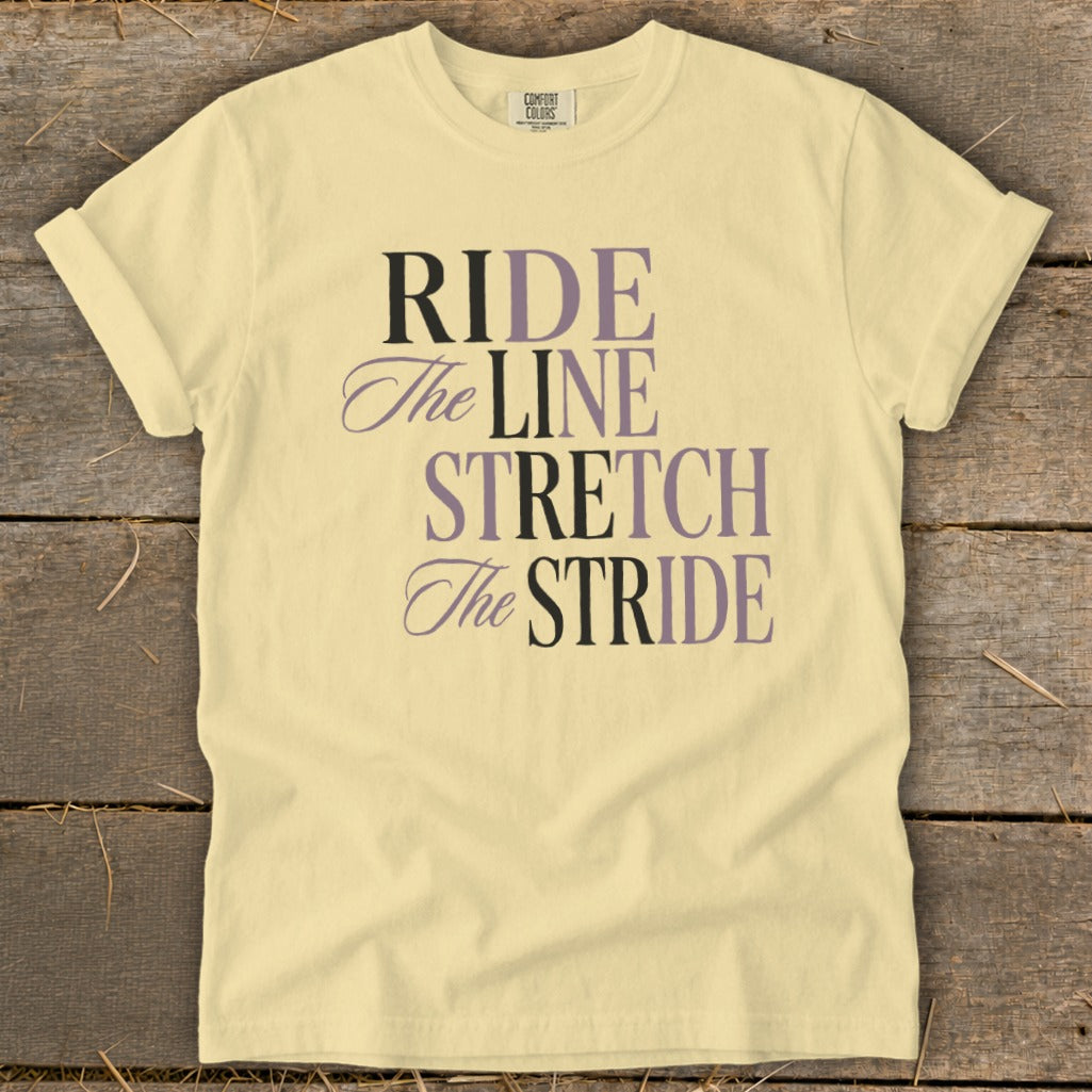 Pale yellow t-shirt with text "RIDE The LINE STRETCH The STRIDE".