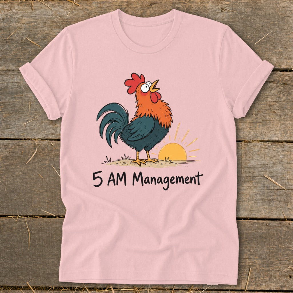 Pink t-shirt with a rooster crowing at sunrise and the text "5 AM Management".