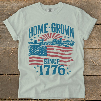 White t-shirt with "Home Grown Since 1776" text and American flag farm scene.