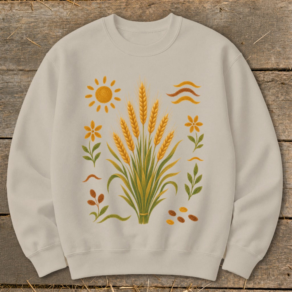Light tan sweatshirt with a graphic of wheat stalks, sun, flowers, and seeds.