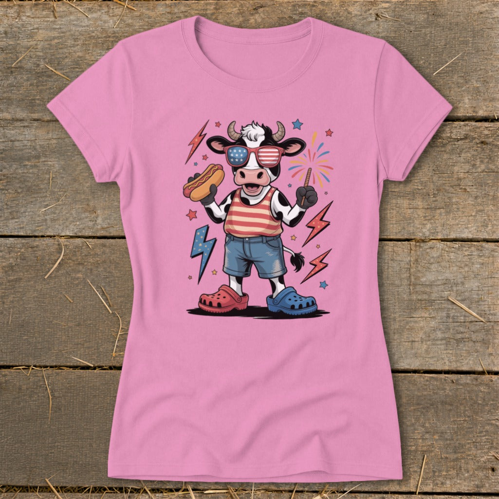 Cartoon cow in sunglasses holding a hot dog with fireworks and lightning bolts.