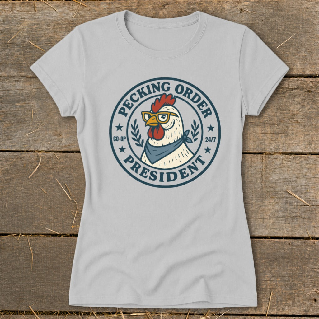 Light grey t-shirt with a circular graphic of a chicken wearing glasses and bandana, reading "Pecking Order President".