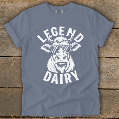 White graphic of a cow wearing sunglasses with text "LEGEND DAIRY" on a blue shirt.