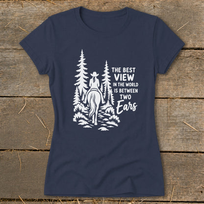 Dark blue women's t-shirt featuring a white graphic of a horse rider in a forest and the text "The best view in the world is between two ears."