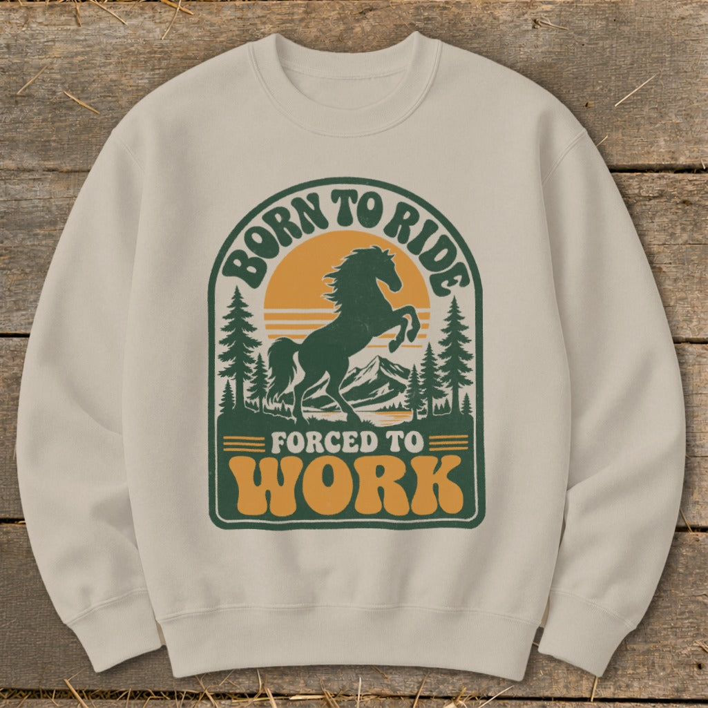 Crewneck sweatshirt with vintage-style graphic of a horse and mountains, reading "Born to Ride Forced to Work".