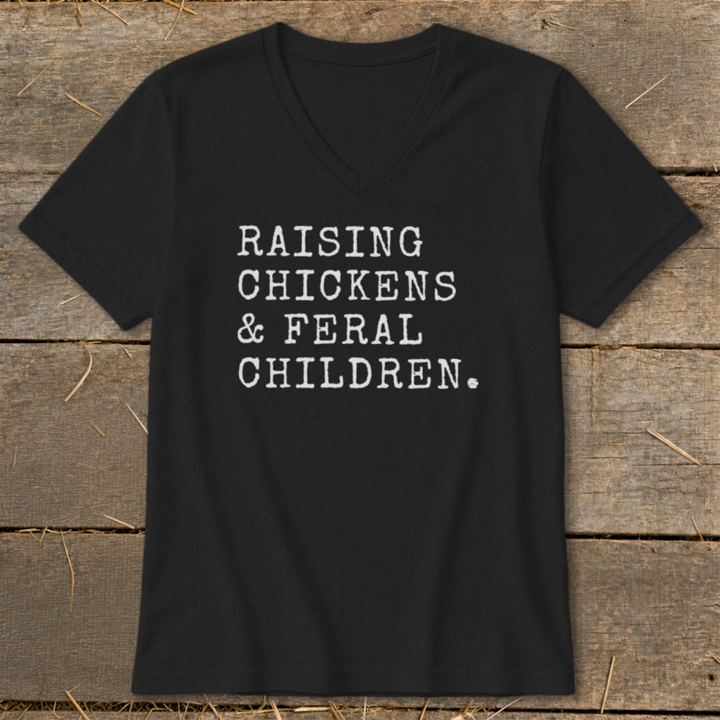 Black v-neck t-shirt with white text: Raising Chickens & Feral Children.