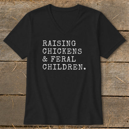 Black v-neck t-shirt with white text: Raising Chickens & Feral Children.