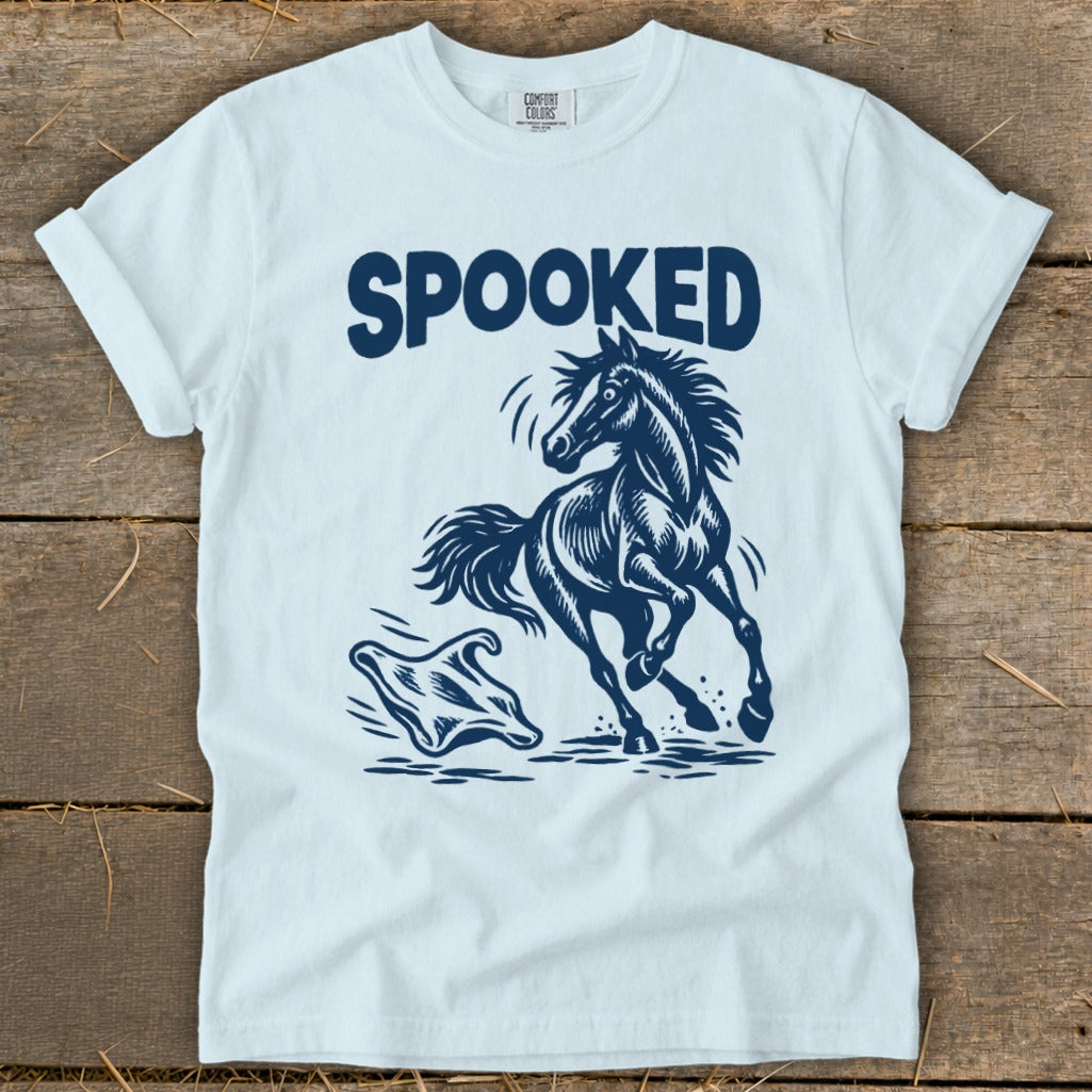 Light blue t-shirt with "SPOOKED" text above a startled horse and ghost graphic.