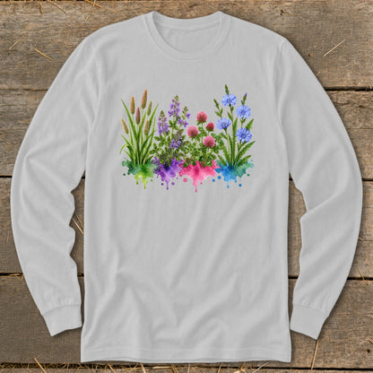 Light gray long-sleeve t-shirt featuring a watercolor botanical illustration of colorful wildflowers with dripping paint effects.