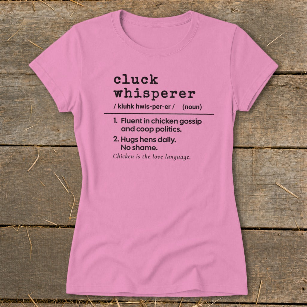 Pink t-shirt with "Cluck Whisperer" definition in black text.
