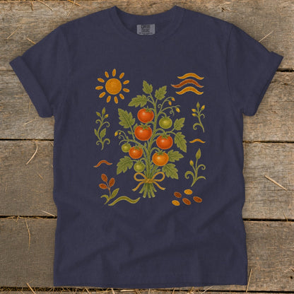 Navy t-shirt with a folk art illustration of a tomato plant, sun, and seeds.