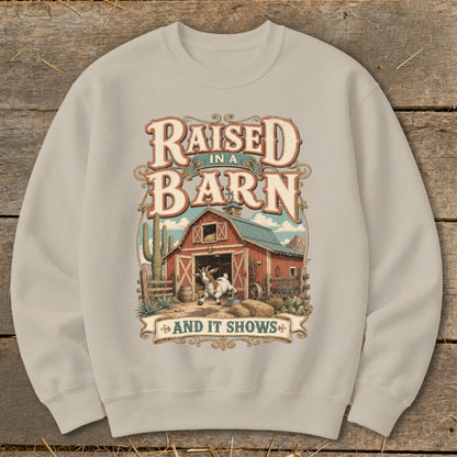 Crewneck sweatshirt with "Raised in a Barn and It Shows" graphic featuring a goat and barn.